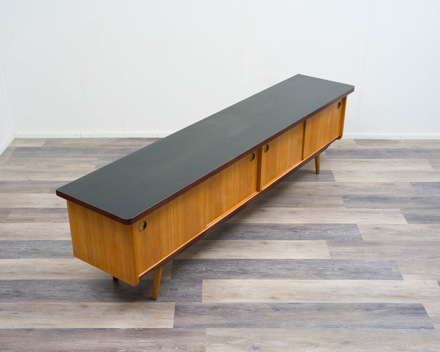 1950s lowboard in ash, surface with black Resopal. Professionally restored