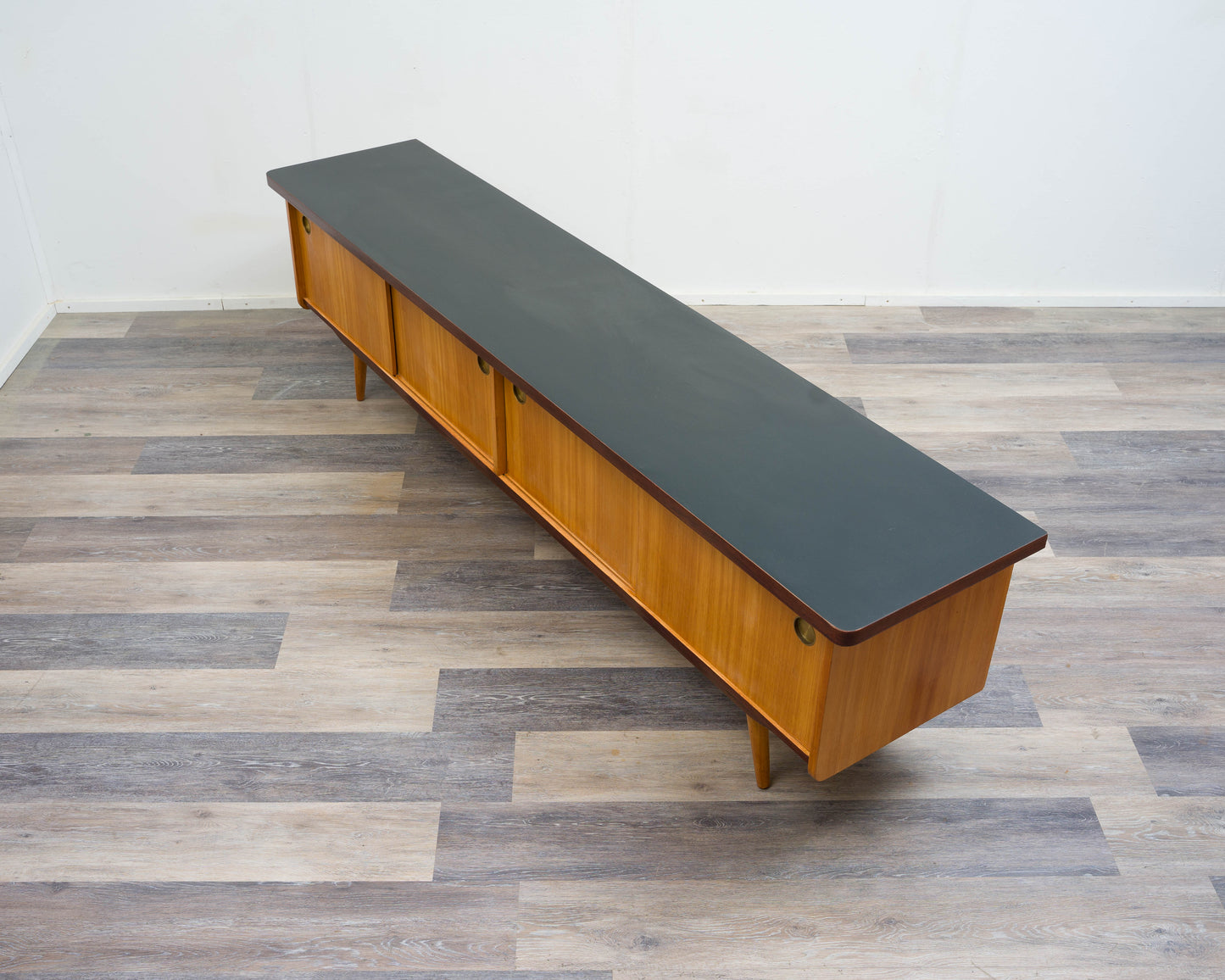 1950s lowboard in ash, surface with black Resopal. Professionally restored