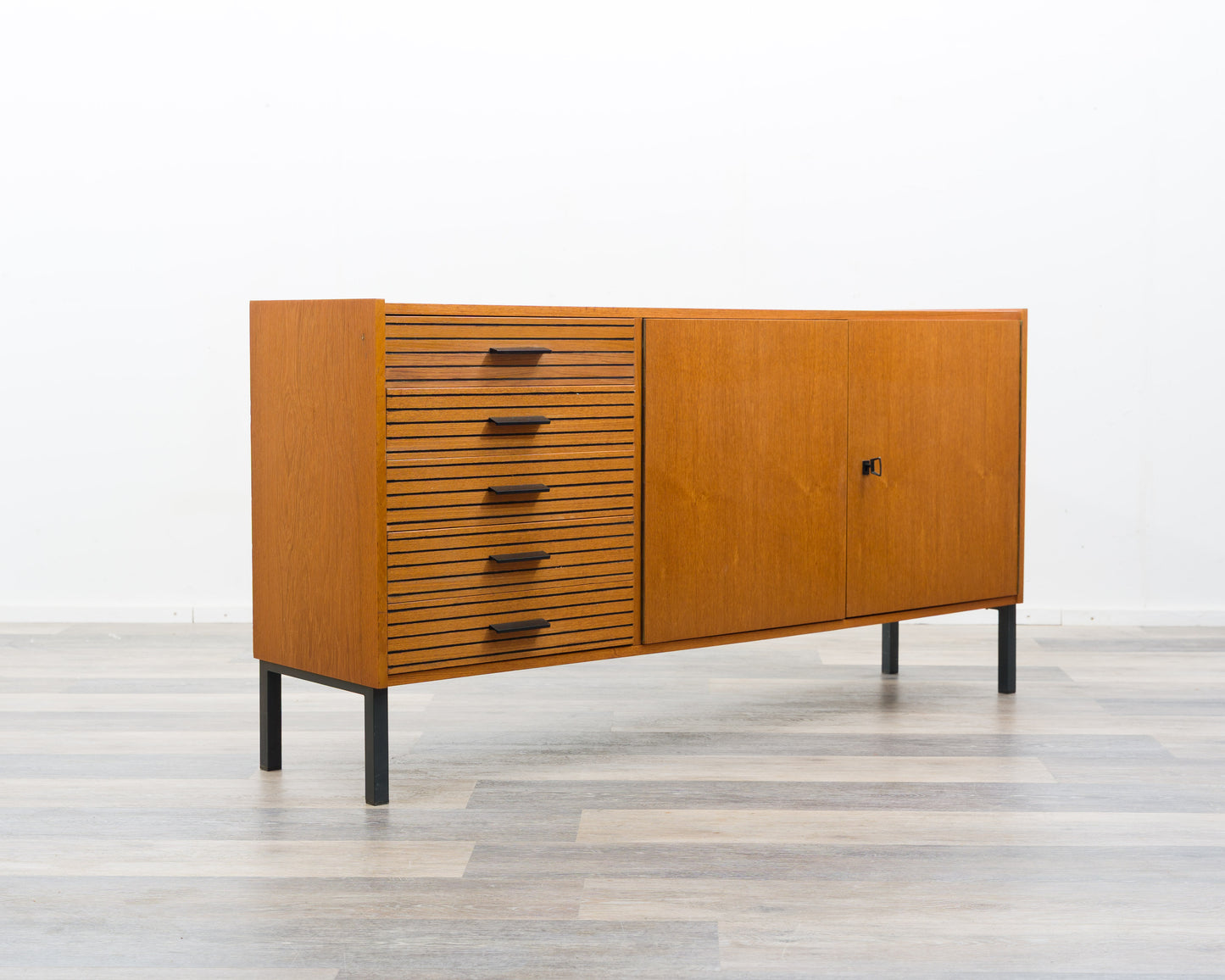 Teak sideboard from the 1960s with grooved drawers.